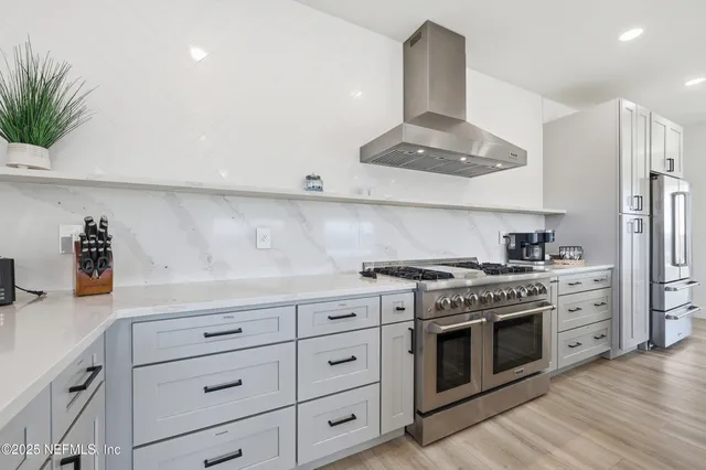 a kitchen with stainless steel appliances a sink stove and cabinets
