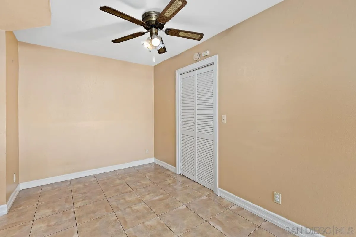 12027 Royal Road, Unit 3 El Cajon, CA 92021 - Photo 12 of 20 an empty room with a ceiling fan and carpet