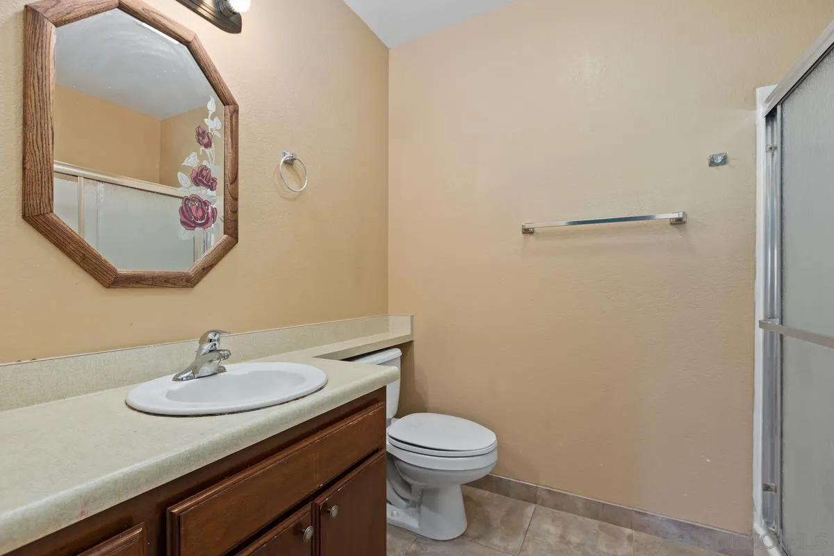 12027 Royal Road, Unit 3 El Cajon, CA 92021 - Photo 17 of 20 a bathroom with a sink a toilet and mirror