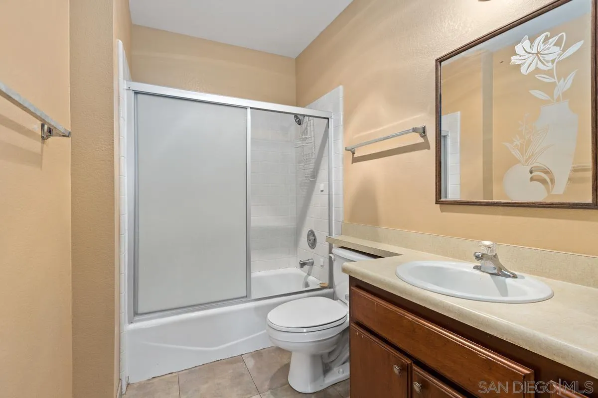 12027 Royal Road, Unit 3 El Cajon, CA 92021 - Photo 18 of 20 a bathroom with a granite countertop sink toilet and shower