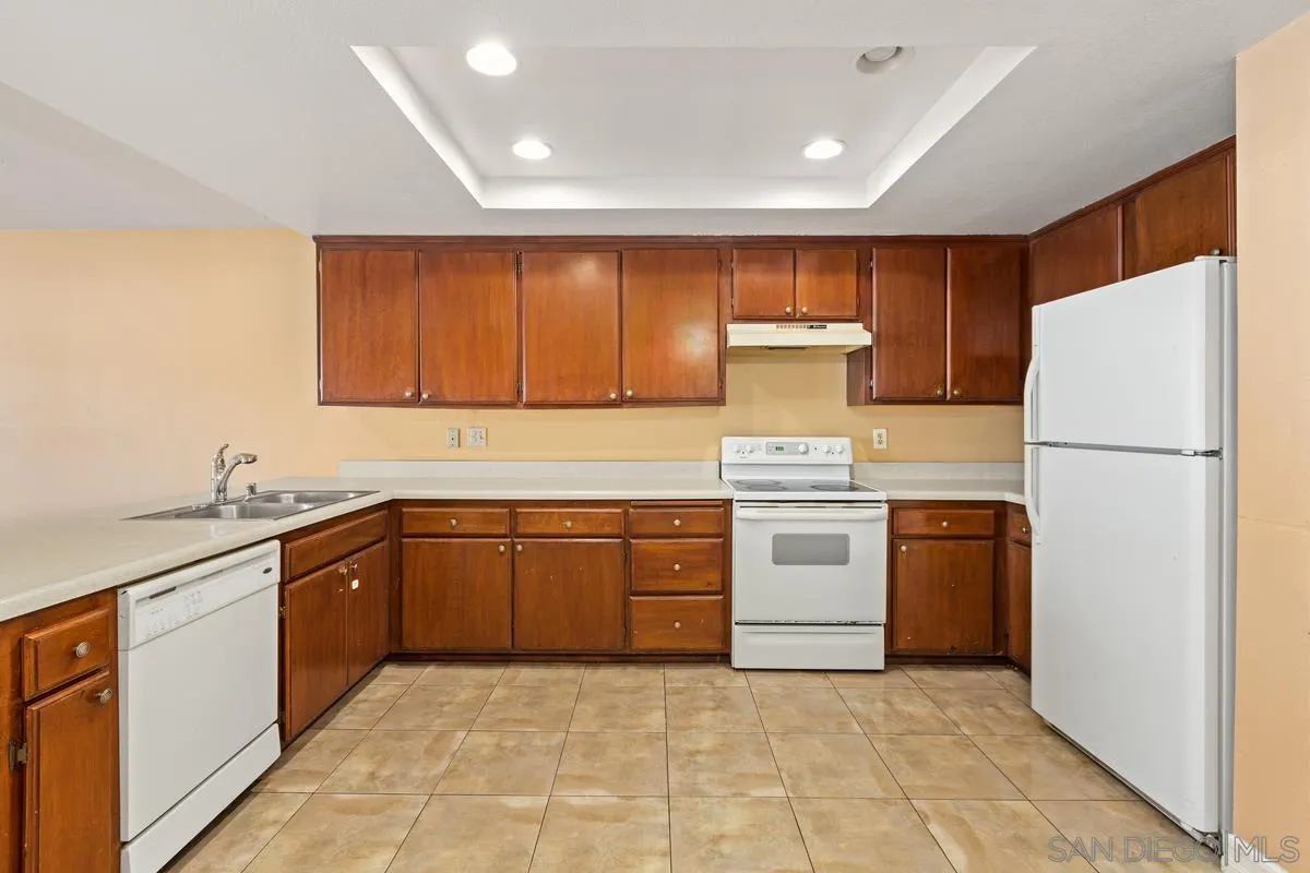 12027 Royal Road, Unit 3 El Cajon, CA 92021 - Photo 5 of 20 a kitchen with a stove top oven sink and refrigerator
