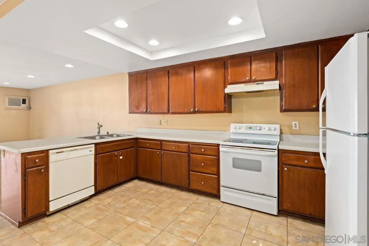 12027 Royal Road, Unit 3 El Cajon, CA 92021 - Photo 6 of 20 a kitchen with a stove top oven sink and cabinets