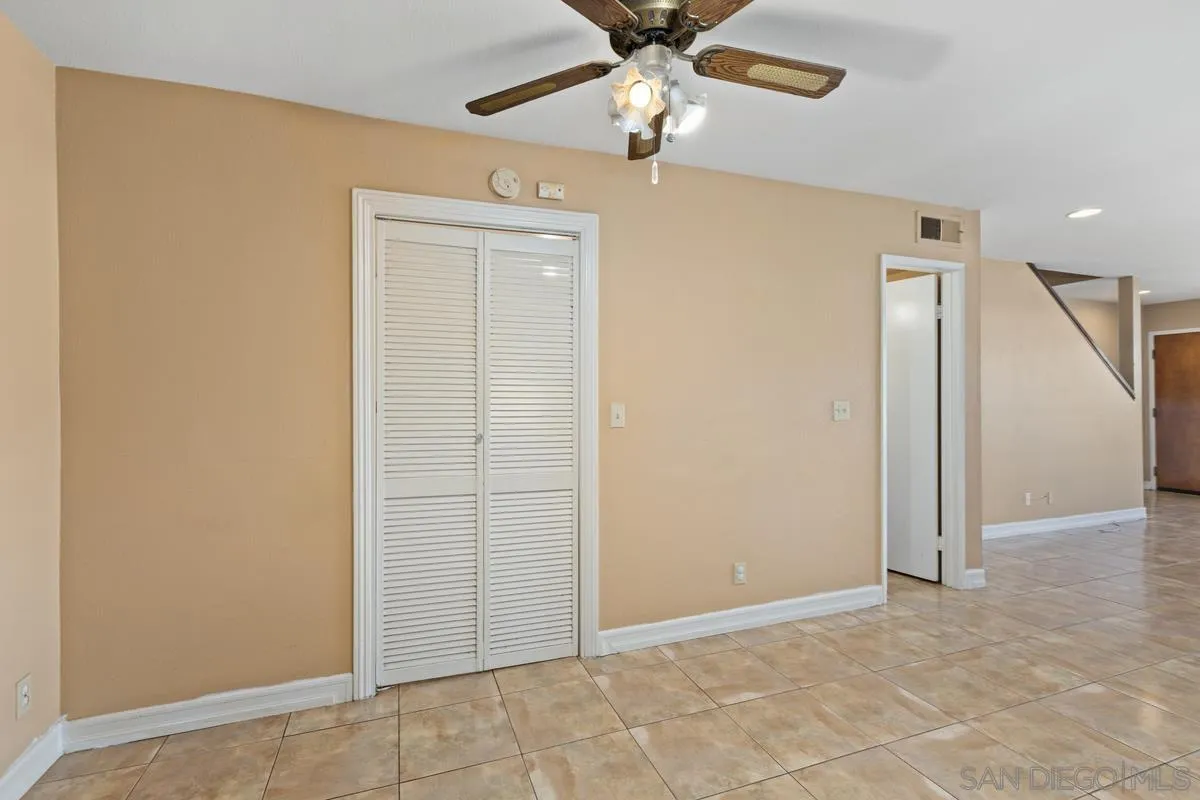 12027 Royal Road, Unit 3 El Cajon, CA 92021 - Photo 8 of 20 an empty room with closet and a chandelier fan