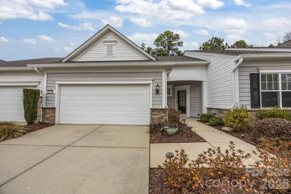 a kitchen with stainless steel appliances white cabinets and a stove top oven