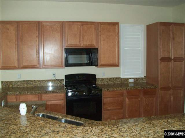 2115 Huntsdale Drive Reno, NV 89521 - Photo 3 of 7 a kitchen with a sink and cabinets