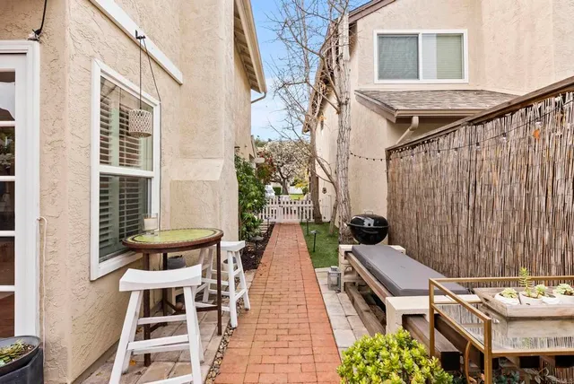 a view of a house with backyard and sitting area