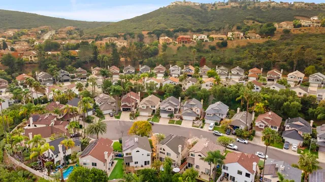 a view of a backyard with table and chairs under an umbrella
