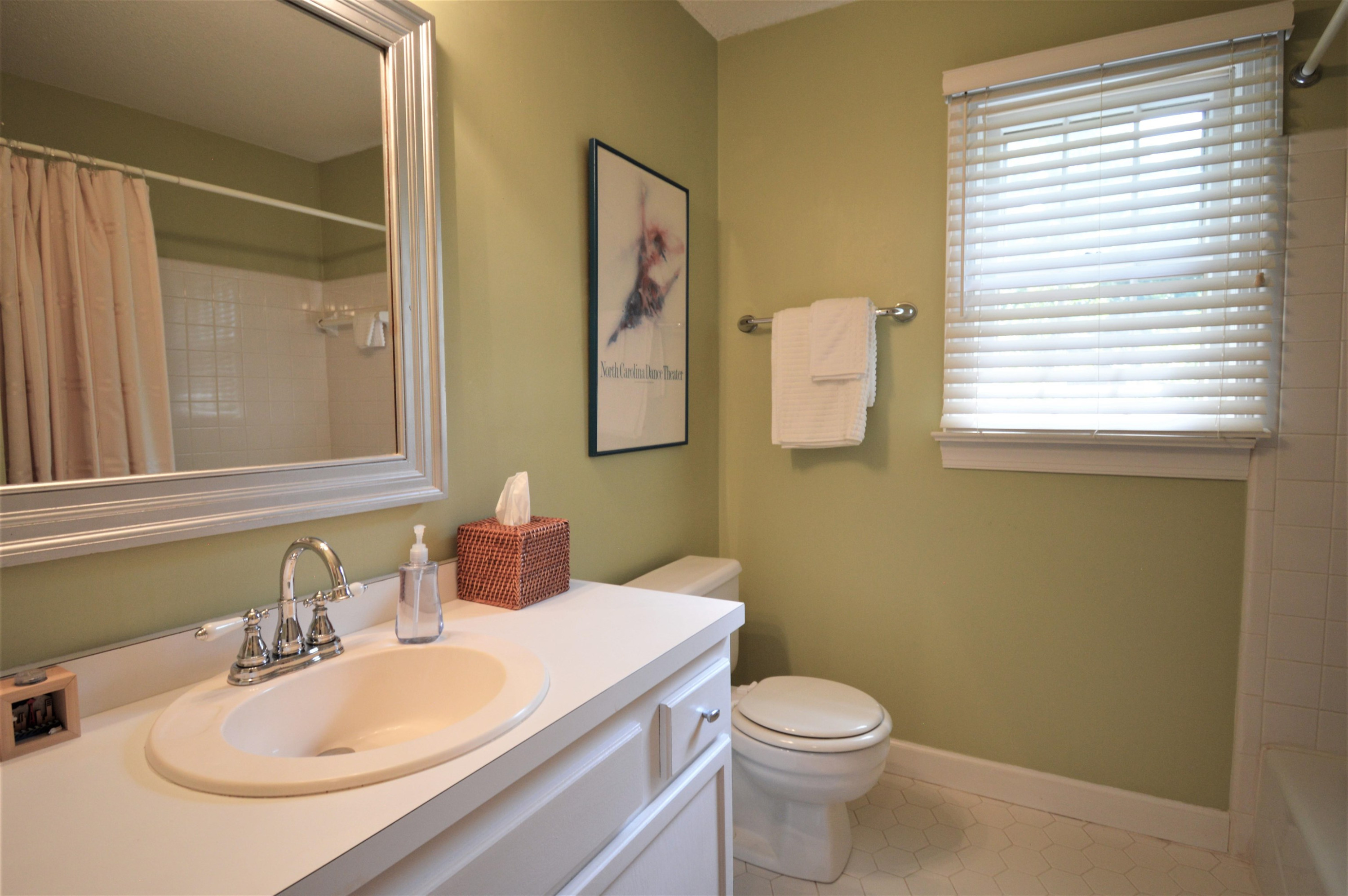 7008 Sandringham Drive Raleigh, NC 27613 - Photo 25 of 52 The upstairs bathroom has ceramic flooring and tile surround. It also has a linen closet! Full Hall Bath