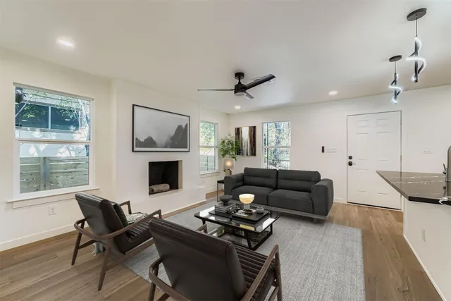 a living room with furniture and kitchen view