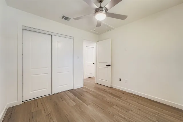 a kitchen with stainless steel appliances granite countertop a refrigerator a stove a sink and a chandelier