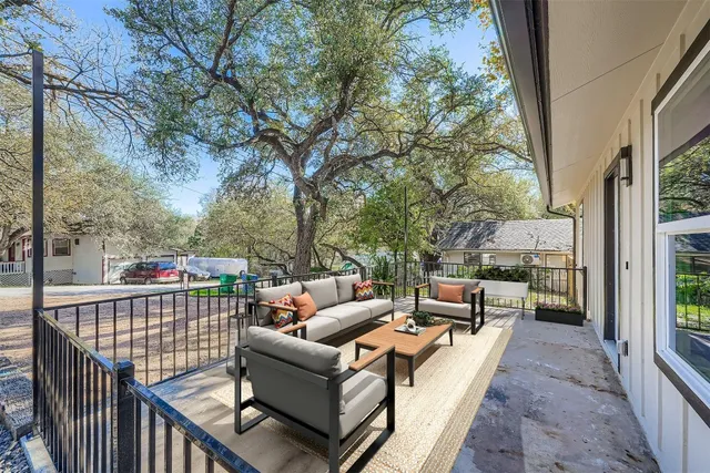a balcony with furniture and wooden floor