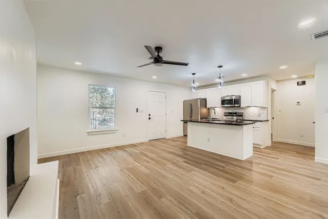 a view of a house with a yard and tree