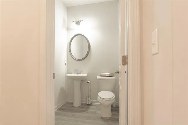 a bathroom with a granite countertop toilet and a sink