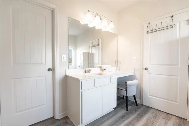 a bathroom with a sink a toilet and mirror