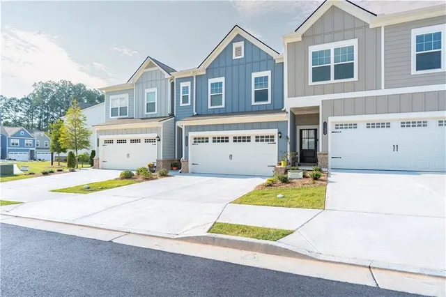 a house with yard and a car park in front of it