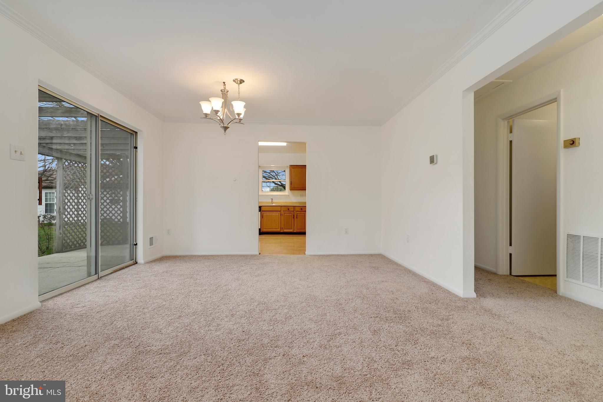 5652 Sandy Court Frederick, MD 21703 - Photo 7 of 35 an empty room with chandelier fan and windows