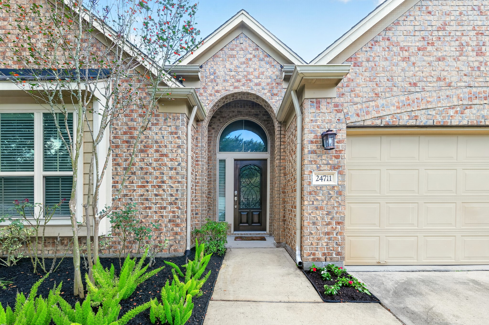 24711 East Burnaby Circle Spring, TX 77373 - Photo 2 of 20 a front view of a house with a garden