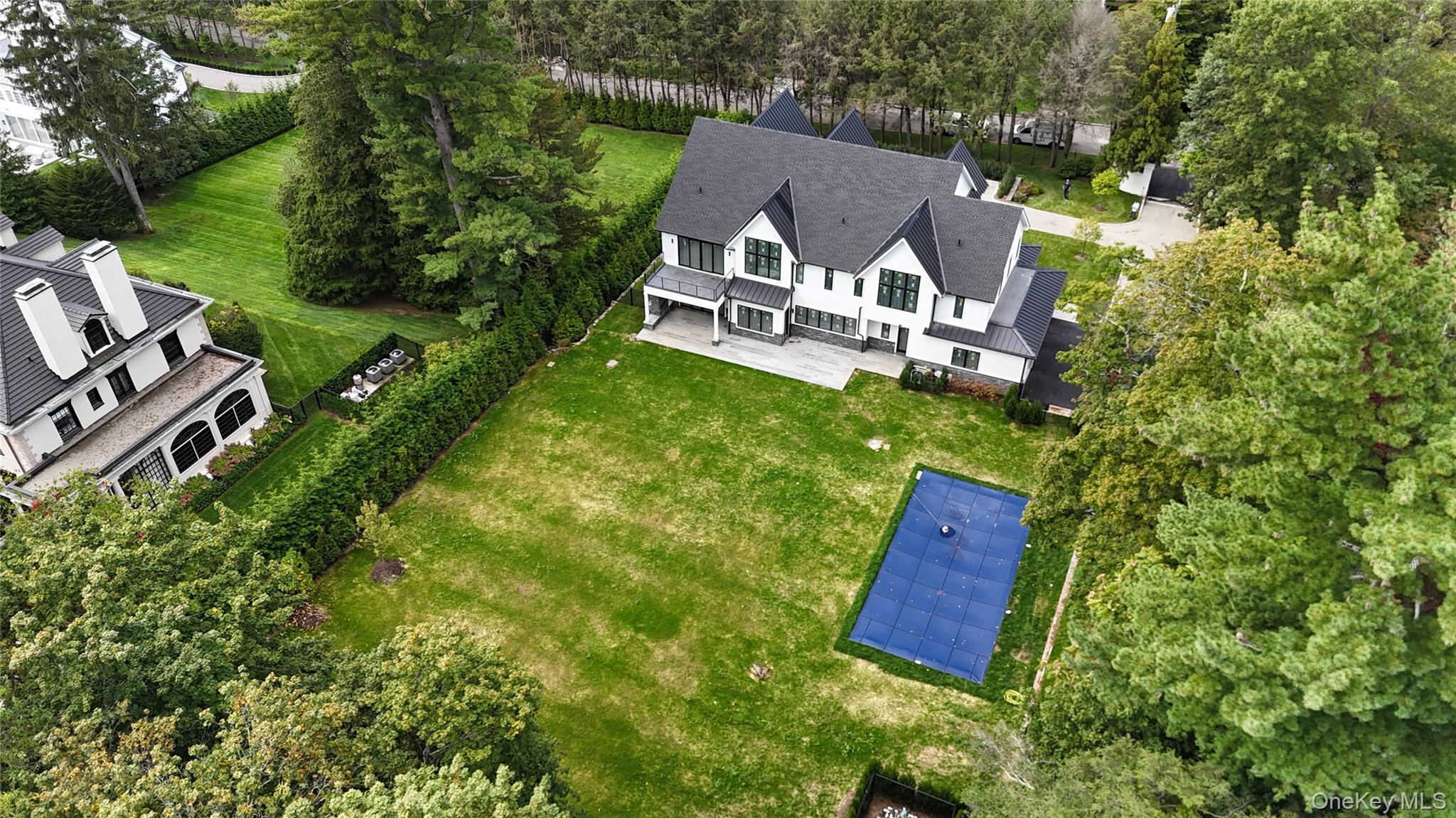 6 Cooper Road Scarsdale, NY 10583 - Photo 2 of 6 an aerial view of a house with garden space and street view
