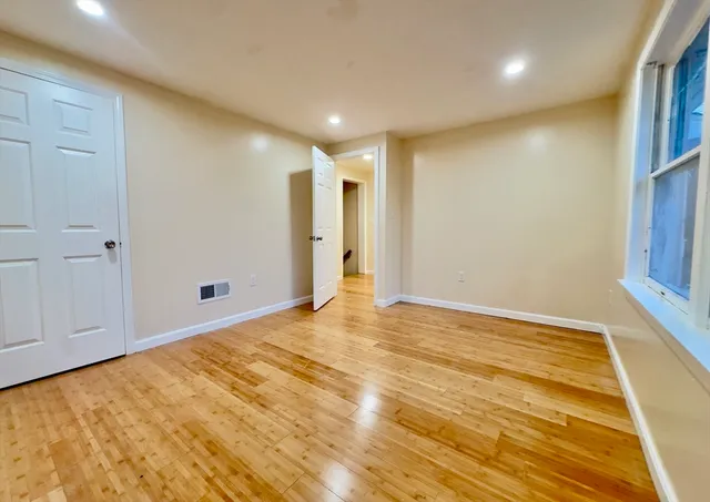 a view of a room with wooden floor and staircase
