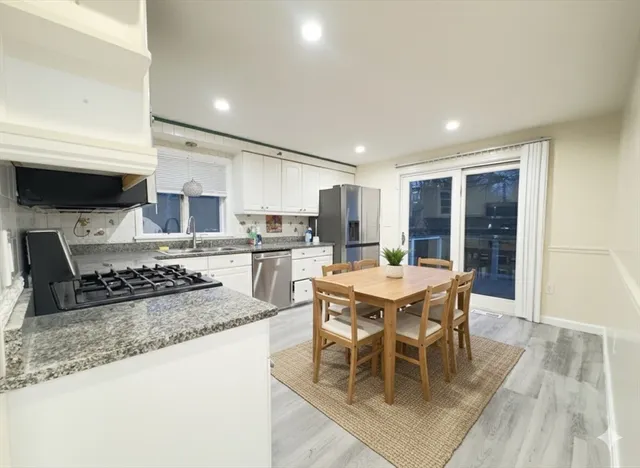 a kitchen with stainless steel appliances granite countertop a stove sink and cabinets