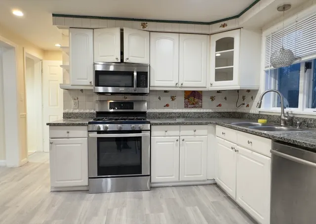 a close view of a sink a faucet and cabinets