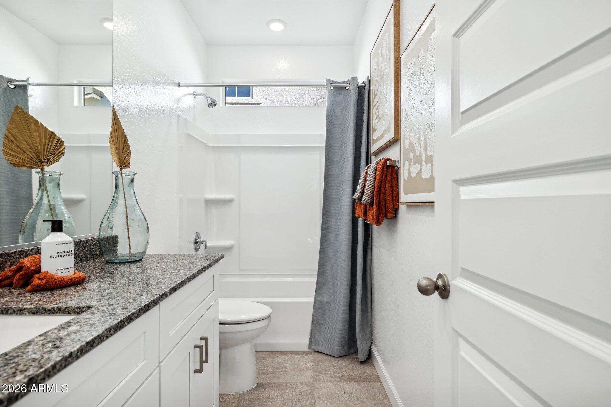 26449 West Crown King Road Buckeye, AZ 85326 - Photo 26 of 33 a bathroom with a granite countertop sink and a mirror