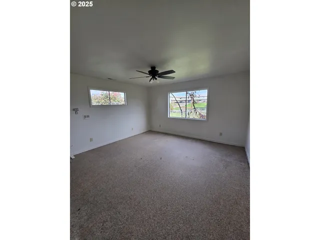 a balcony with chairs and a table in it