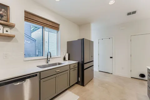 a kitchen with a refrigerator and a sink