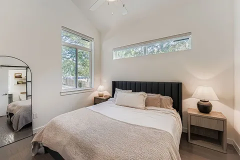 a bedroom with a bed and wooden floor