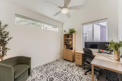 a living room with furniture and a rug