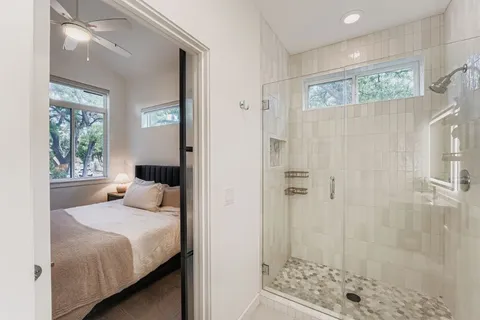 a bedroom with a bed and a window