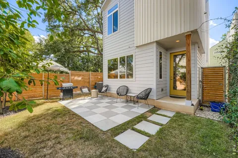 a view of a backyard with sitting area