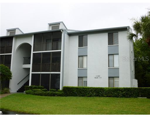 1204 Pine Ridge Circle West, Unit F1 Tarpon Springs, FL 34688 - Photo 1 of 1 a front view of a house with a yard