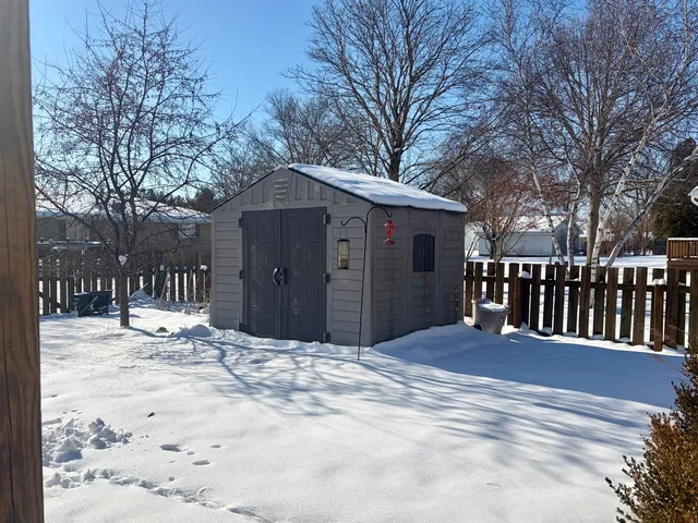 a view of house with a yard covered in snow