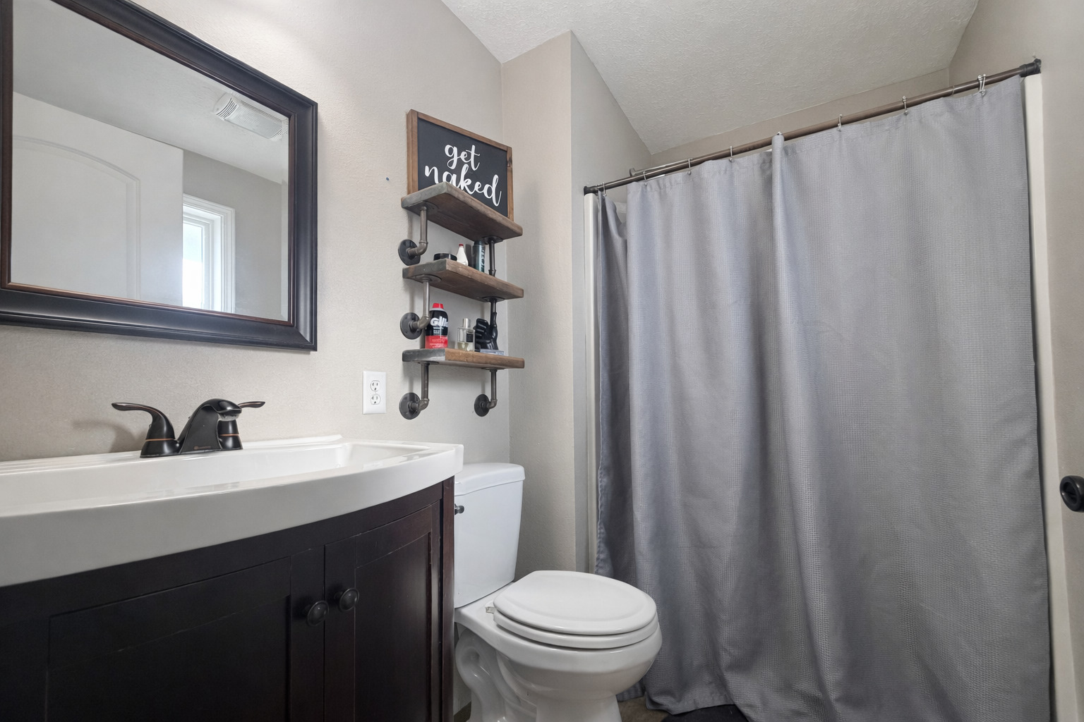 502 Kenneth Drive Heyworth, IL 61745 - Photo 9 of 18 a bathroom with a sink a toilet and a mirror