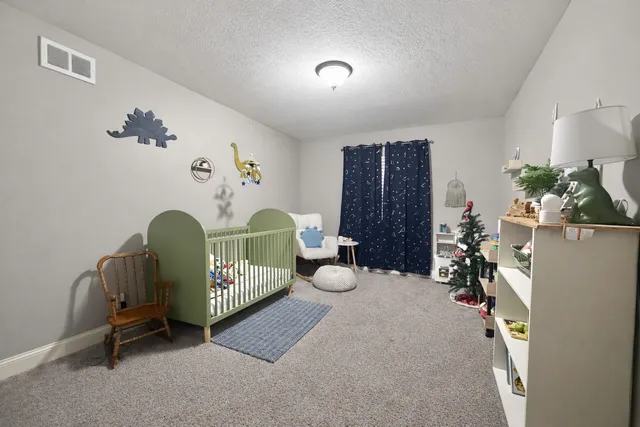 a bedroom with furniture and a large window