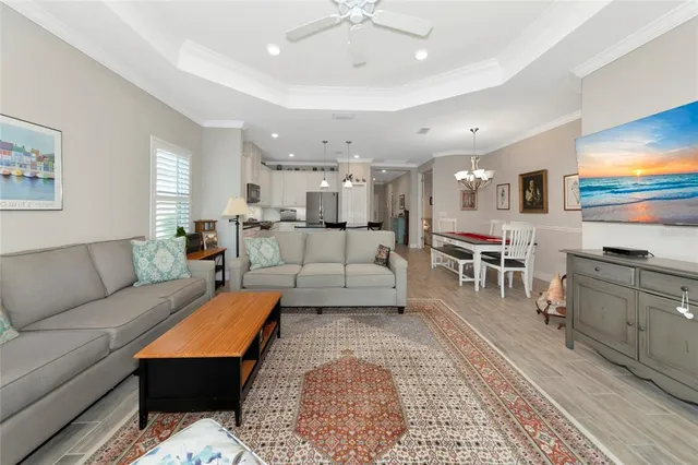 a living room with furniture and a kitchen view
