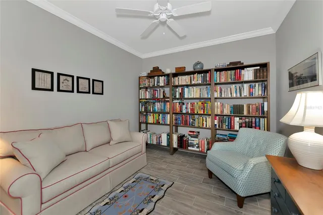 a living room with furniture and a book shelf