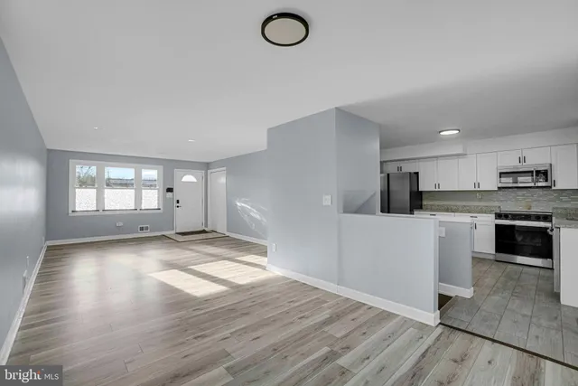 a view of kitchen with a sink wooden floor and kitchen