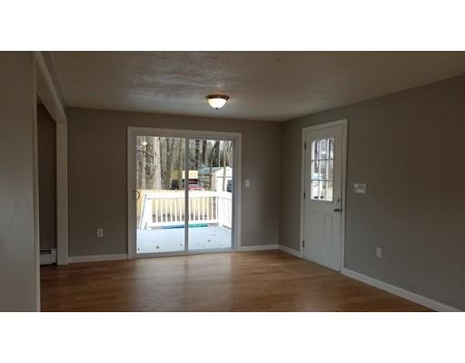 454 Middlesex Turnpike Billerica, MA 01821 - Photo 6 of 15 a open hall with a floor to ceiling window and wooden floor