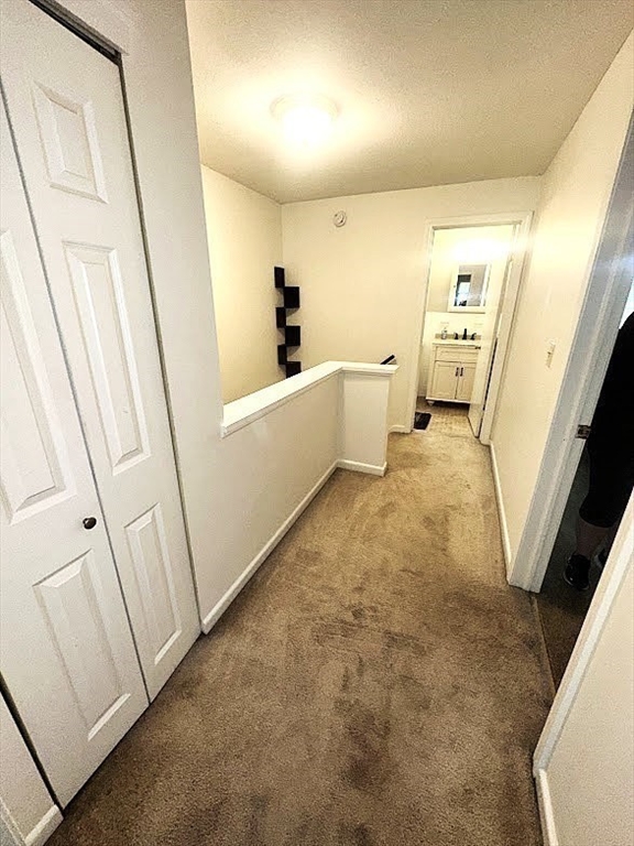 540 Granby Road, Unit 62 South Hadley, MA 01075 - Photo 12 of 20 a view of a hallway with white cabinets and dryer