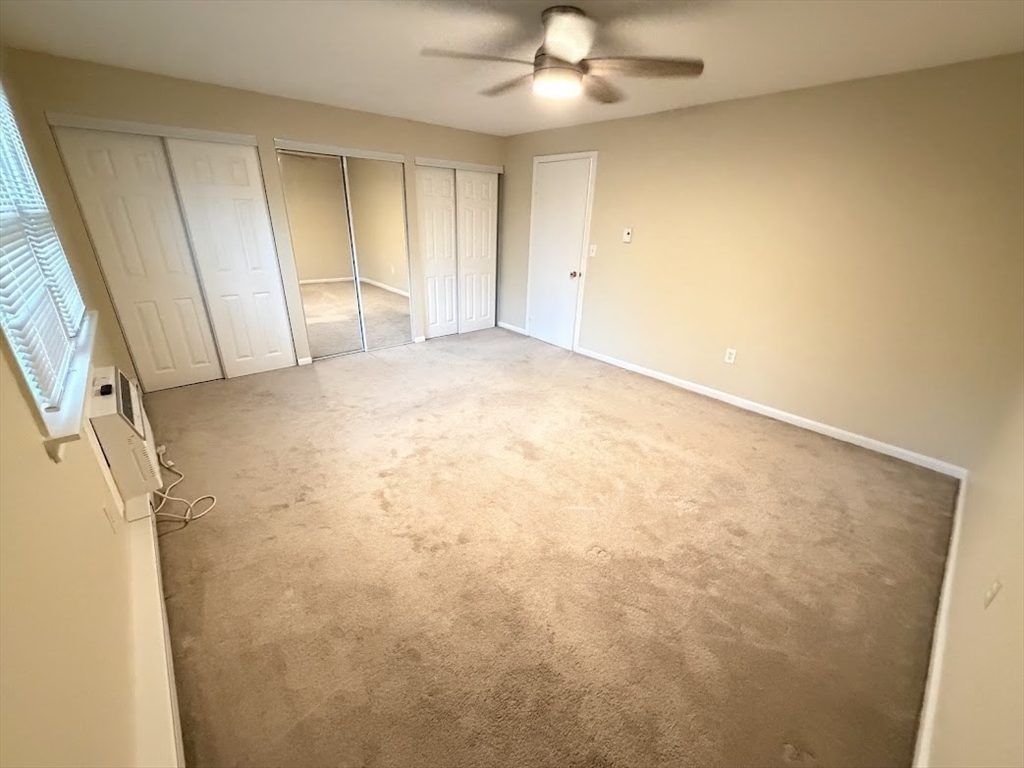 540 Granby Road, Unit 62 South Hadley, MA 01075 - Photo 15 of 20 an empty room with a ceiling fan and carpet