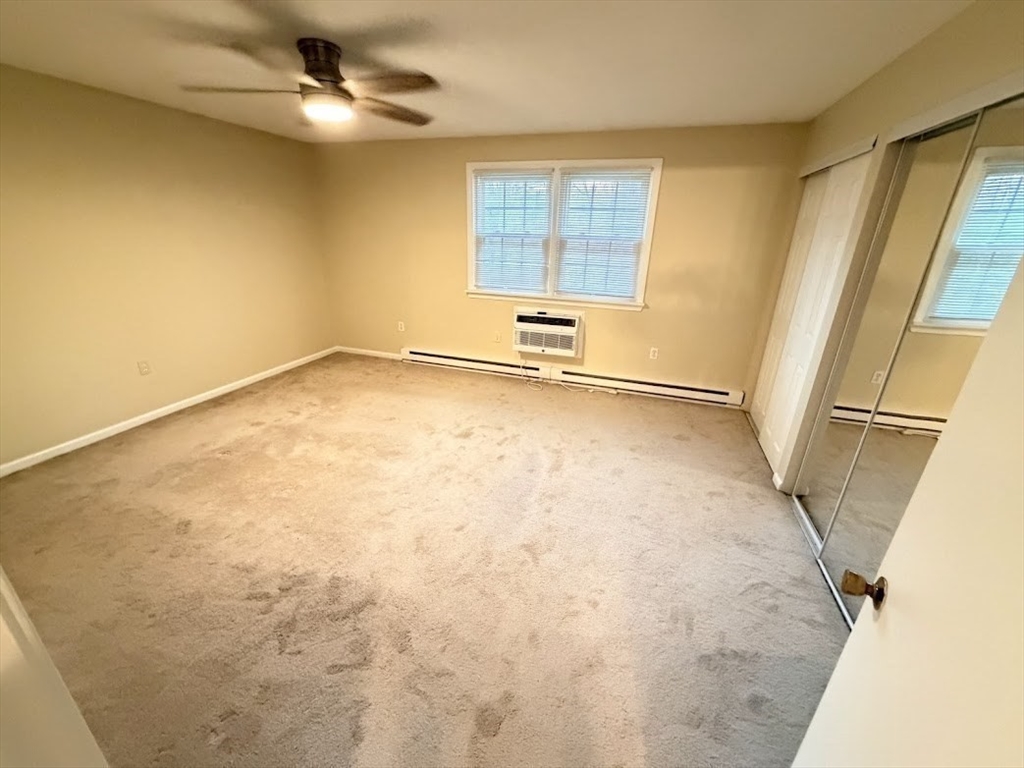 540 Granby Road, Unit 62 South Hadley, MA 01075 - Photo 16 of 20 a view of empty room with wooden floor and fan