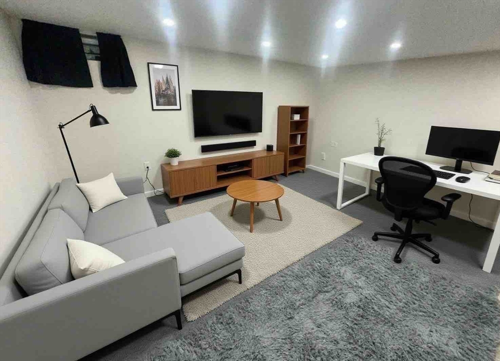 540 Granby Road, Unit 62 South Hadley, MA 01075 - Photo 18 of 20 a living room with furniture and a flat screen tv