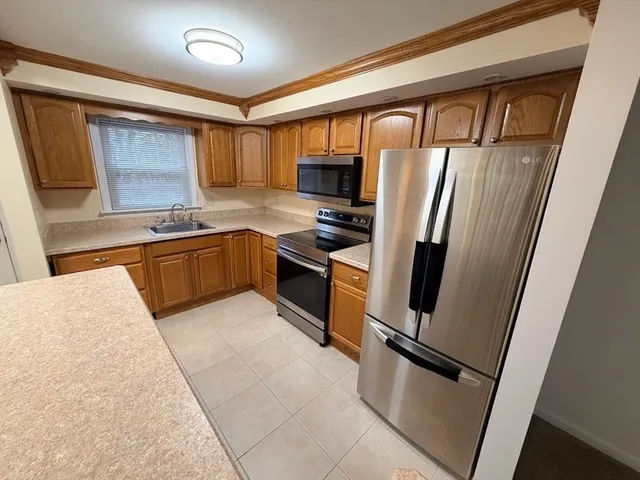 a kitchen with stainless steel appliances granite countertop refrigerator a sink a stove a microwave and island