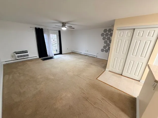 a view of a room with window and wooden floor