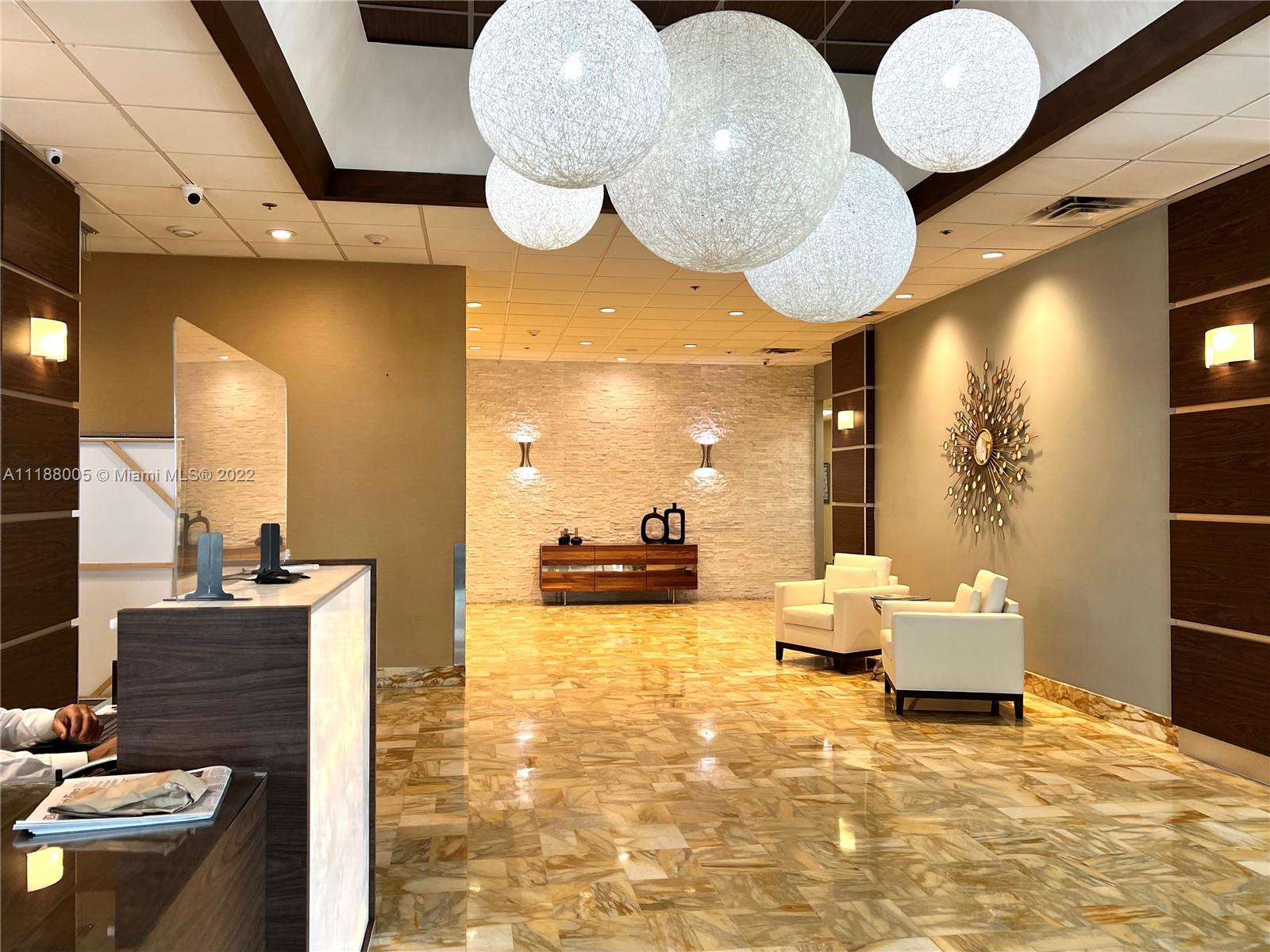 9511 Collins Avenue, Unit 308 Surfside, FL 33154 - Photo 3 of 14 a bathroom with a sink and a mirror