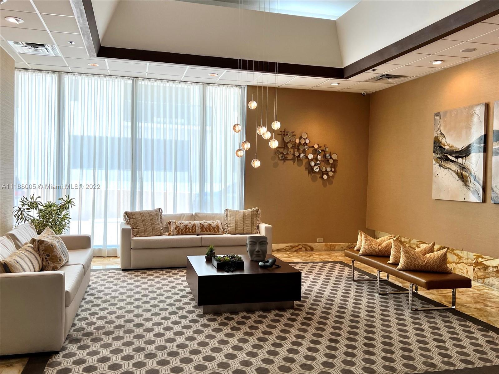 9511 Collins Avenue, Unit 308 Surfside, FL 33154 - Photo 4 of 14 a living room with furniture and a large window