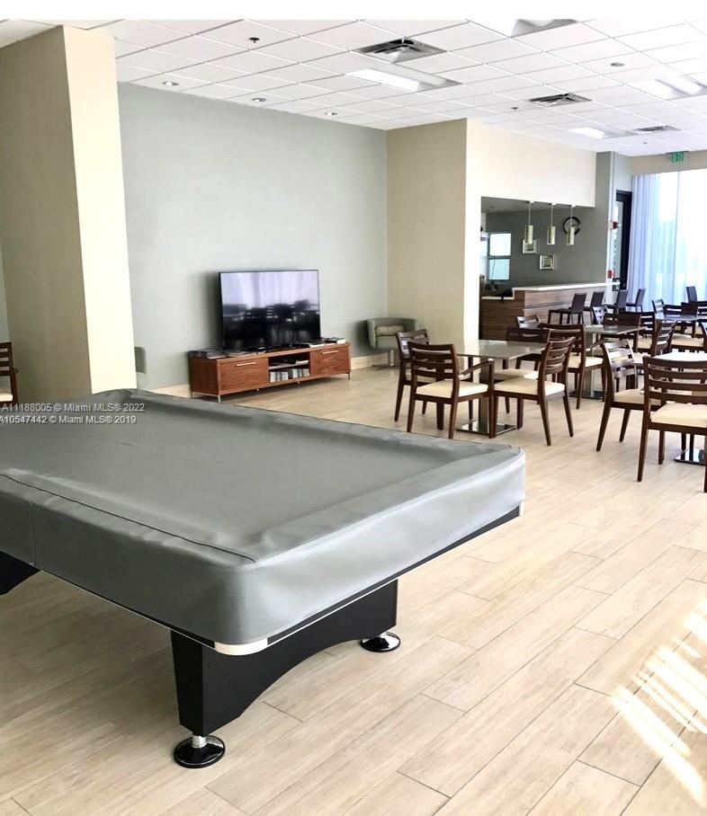 9511 Collins Avenue, Unit 308 Surfside, FL 33154 - Photo 7 of 14 a living room with furniture and a table