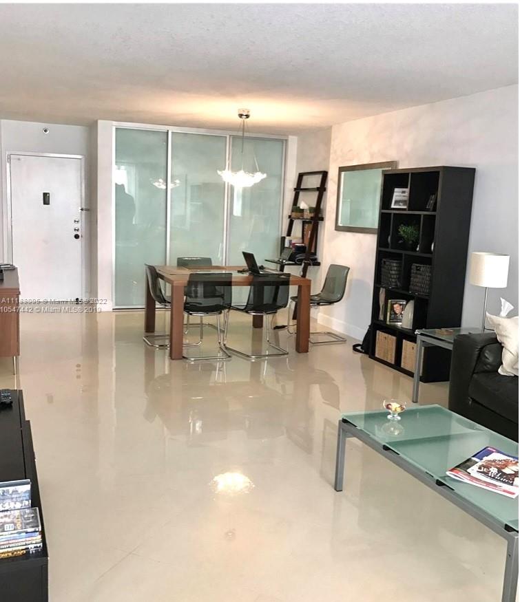 9511 Collins Avenue, Unit 308 Surfside, FL 33154 - Photo 9 of 14 a living room with furniture and wooden floor